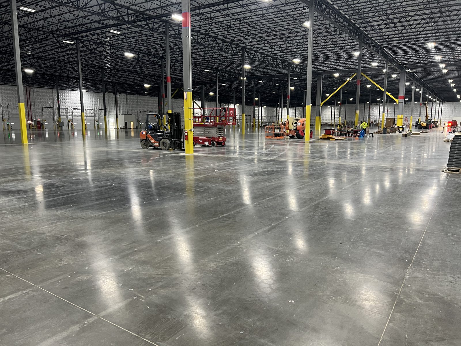 Distribution center under construction with lifts and equipment on the floor